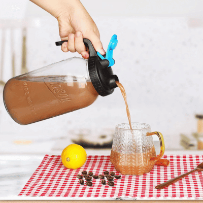 Tea Pitcher Pouring into Glass Cup