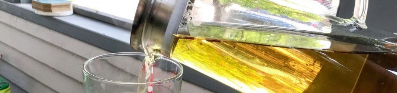 Tea Pitcher Pouring Into Glass