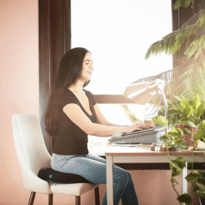 Woman In Chair at Desk With Ergonomic Donut Pillow