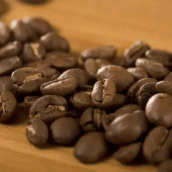 Dark roast coffee beans shown on a table