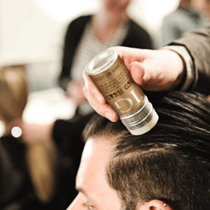 Applying Tigi Hair Wax to man's hair
