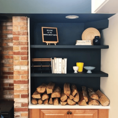 Floating wood shelve installed in a nook above firewood storage