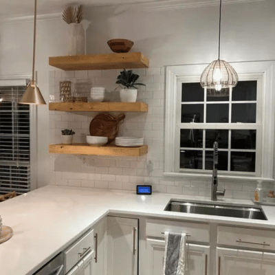 Floating wood shelves installed over the kitchen counter