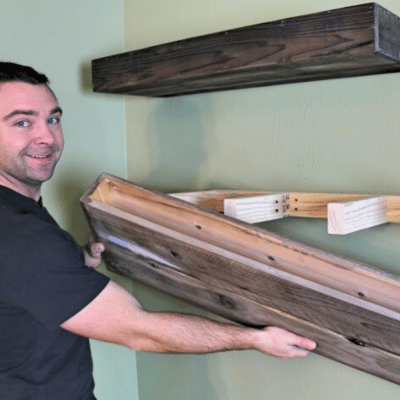 Man installing a floating wood shelf