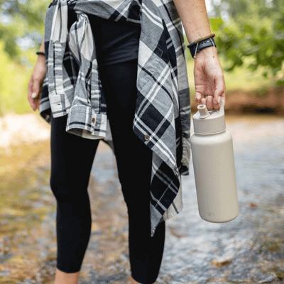 Woman walking with a Simple Modern stainless steel water bottle