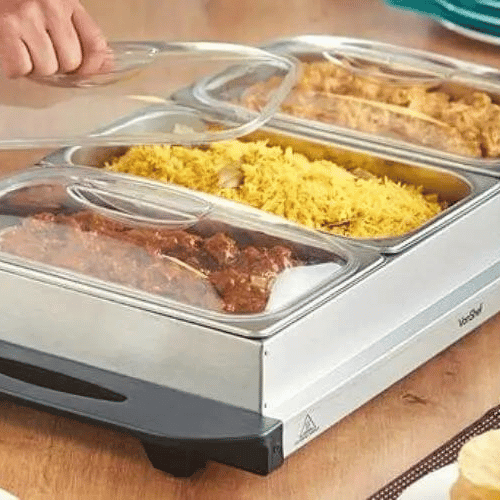 Hand lifting the lid from the middle warmer of a warming tray