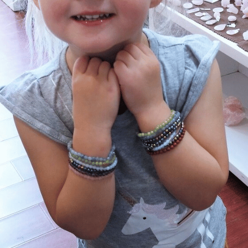 Child with multiple pyrite bracelets