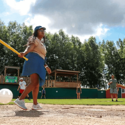 Girl at bat in a wiffle ball game