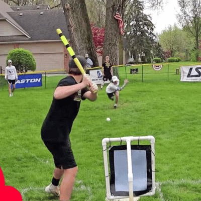 Batter ready to swing during a backyard wiffle ball game