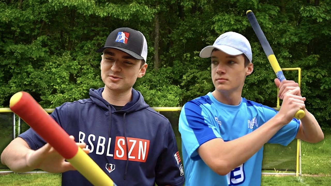 Two boys showing taped wiffle ball bats