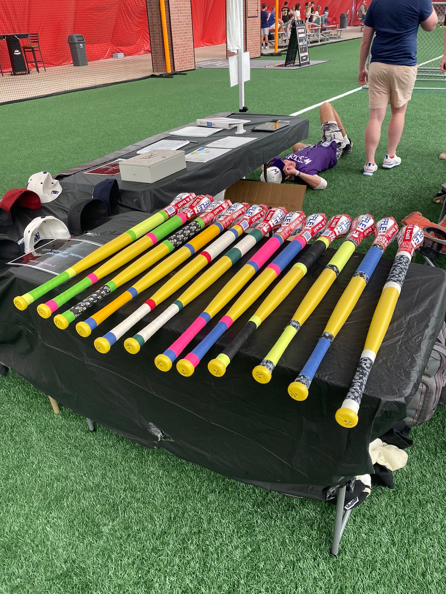 Exhibit showcasing various taped wiffle ball bats