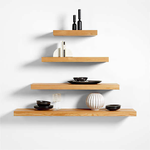 Four floating shelves of different sizes on a wall