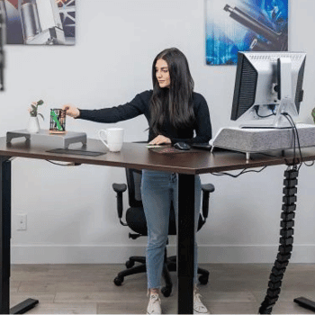 Woman standing at a modern home office standing desk