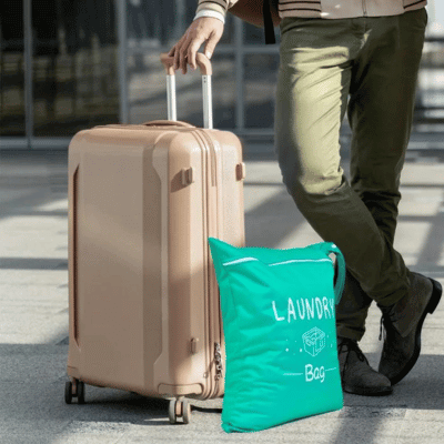 Waterproof travel laundry bag next to a suitcase