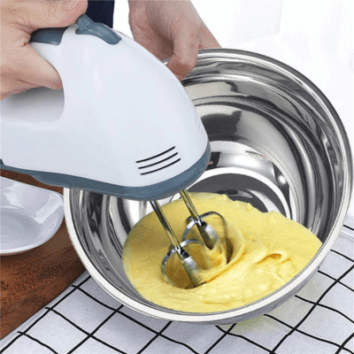 Person using a stainless steel bowl for baking