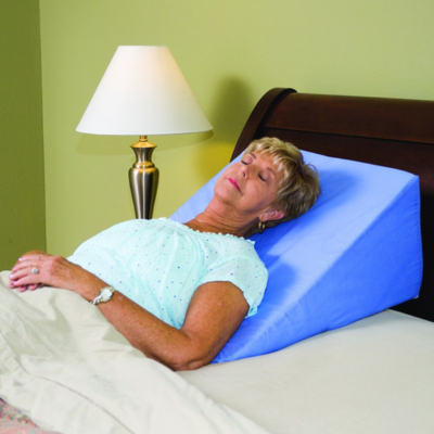 Woman sleeping on a medical bed wedge pillow