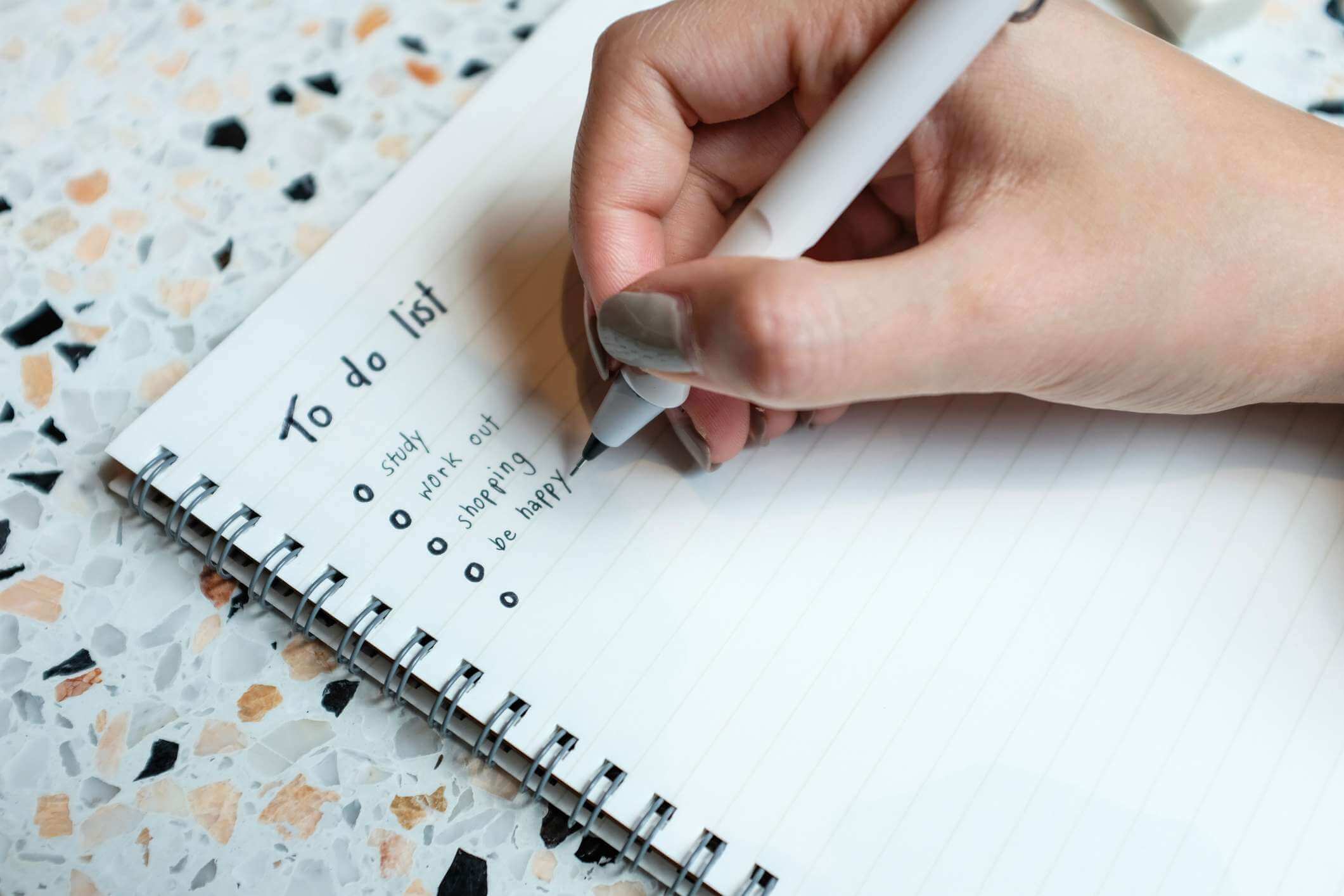 A person making entries in an ADHD bullet journal
