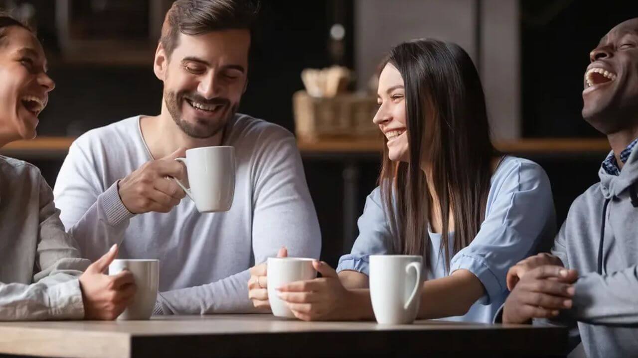 People drinking coffee from a handmade ceramic mug