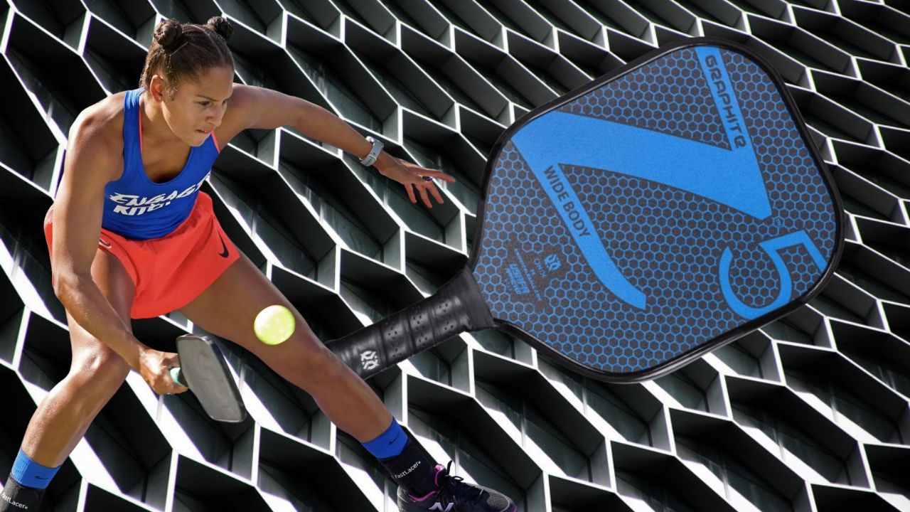 Woman pickleball player in action with pickleball paddle on a pickleball paddle surface