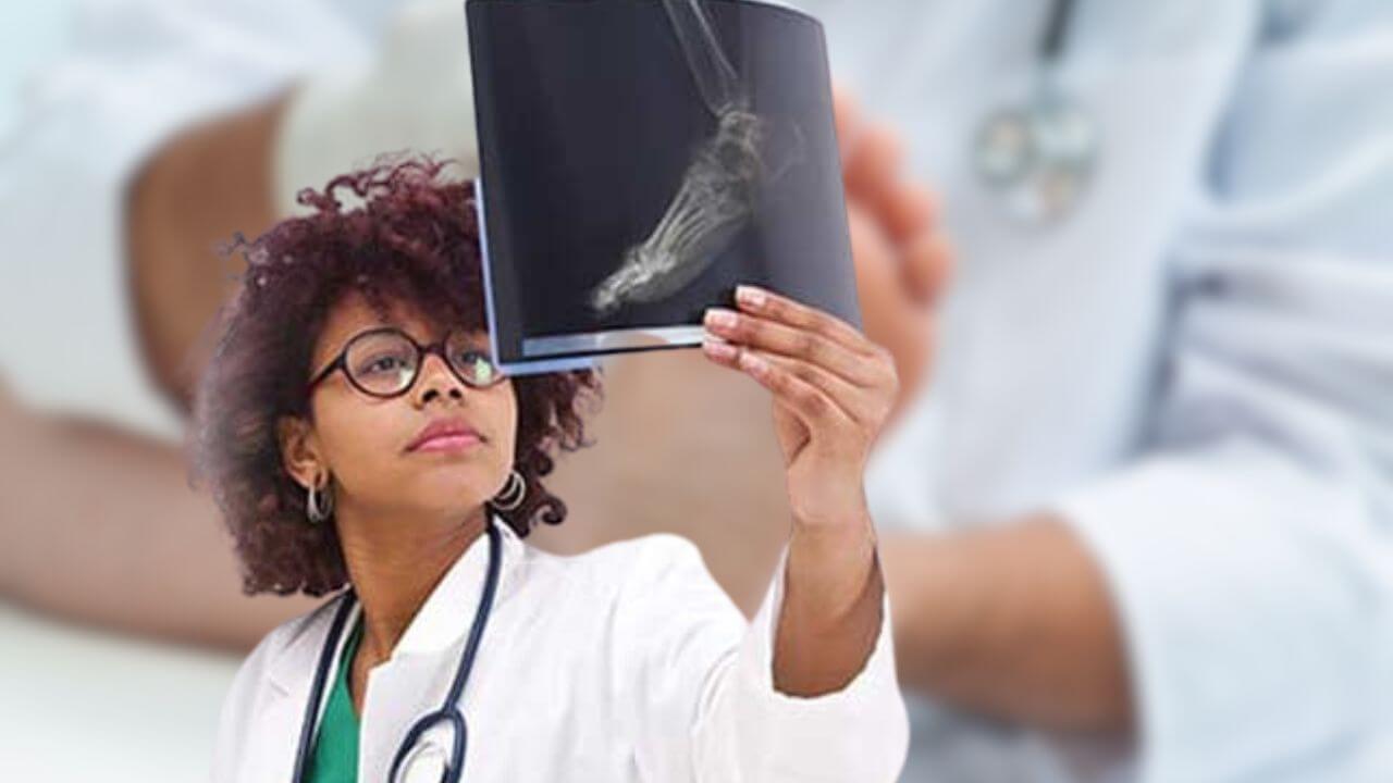 A woman podiatrist examining foot X-ray
