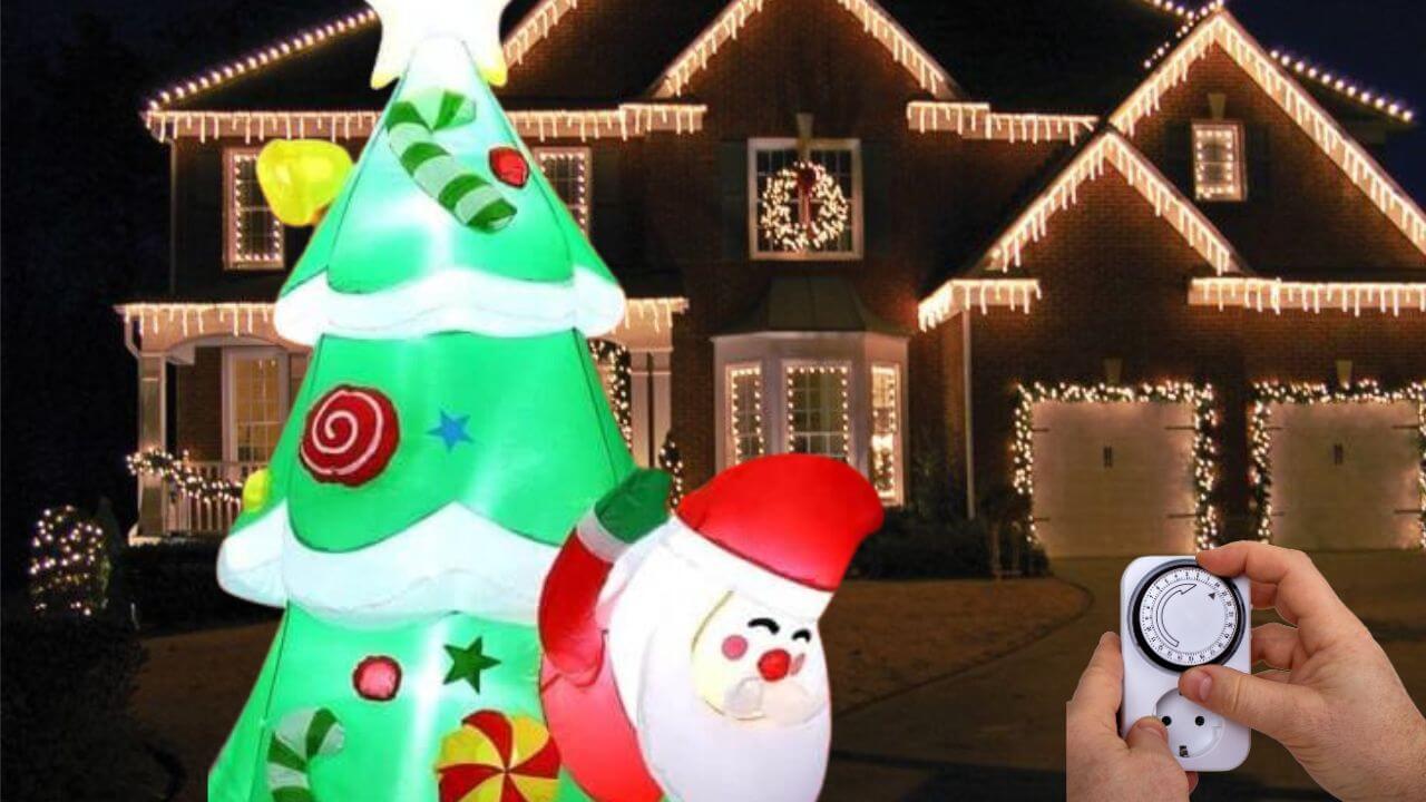 Person setting a 24/7 timer for a Christmas tree inflatable in front of a house