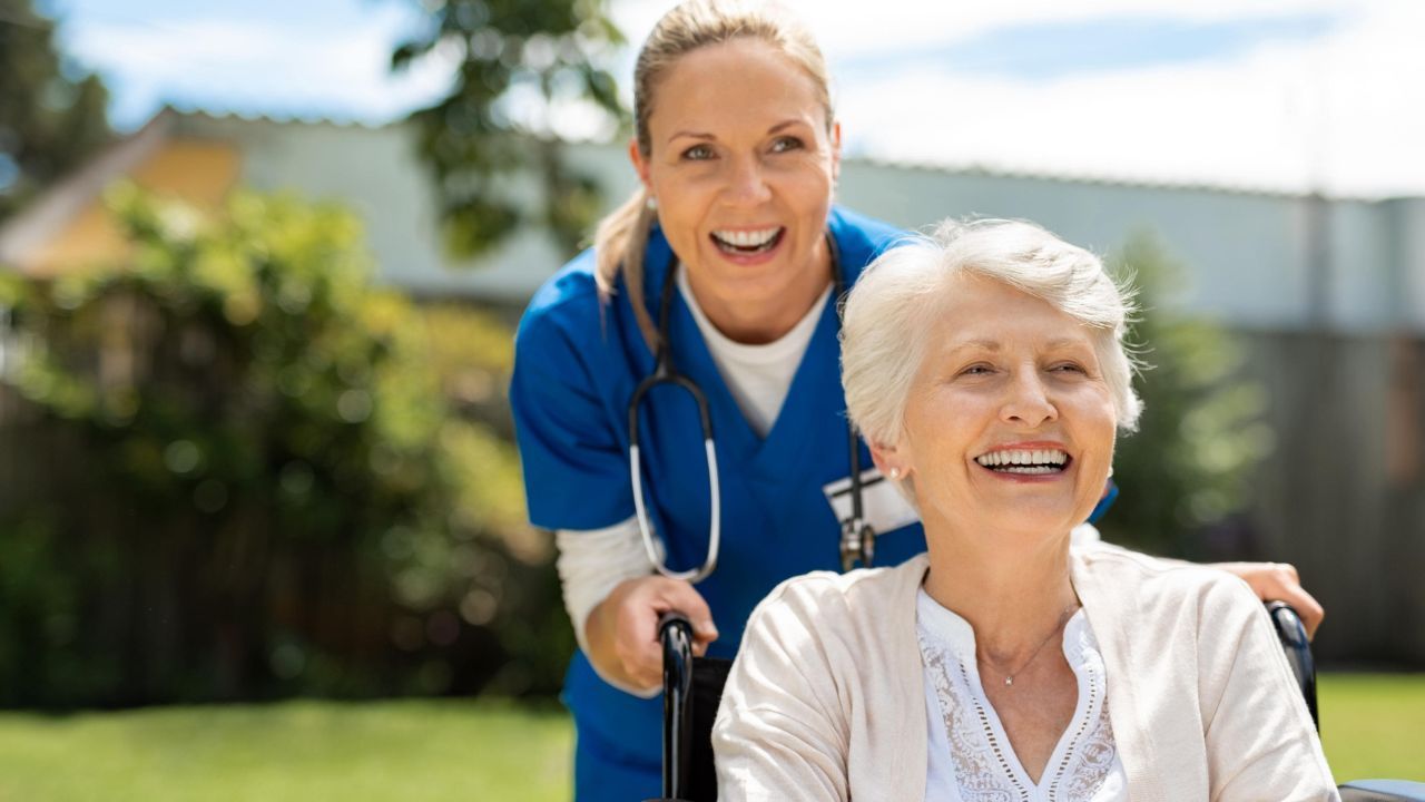 Health professional is escorting a woman in a wheelchair