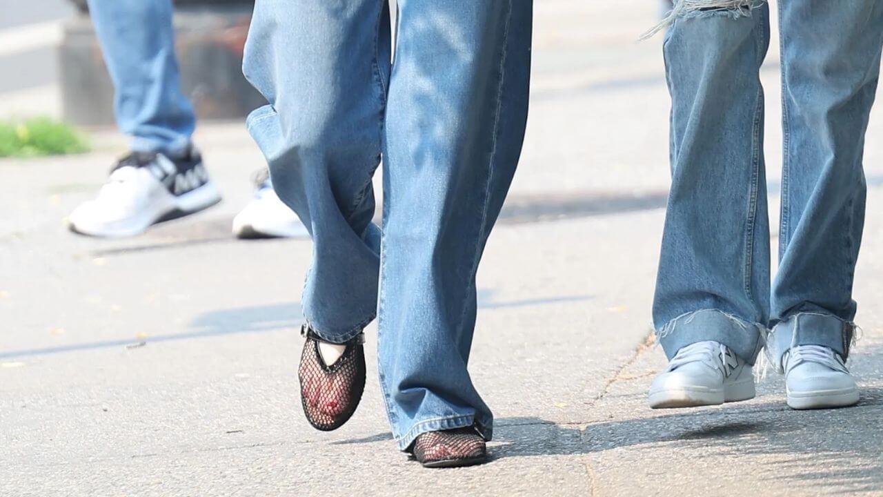 Person walking on the sidewalk in ballet mesh flats 