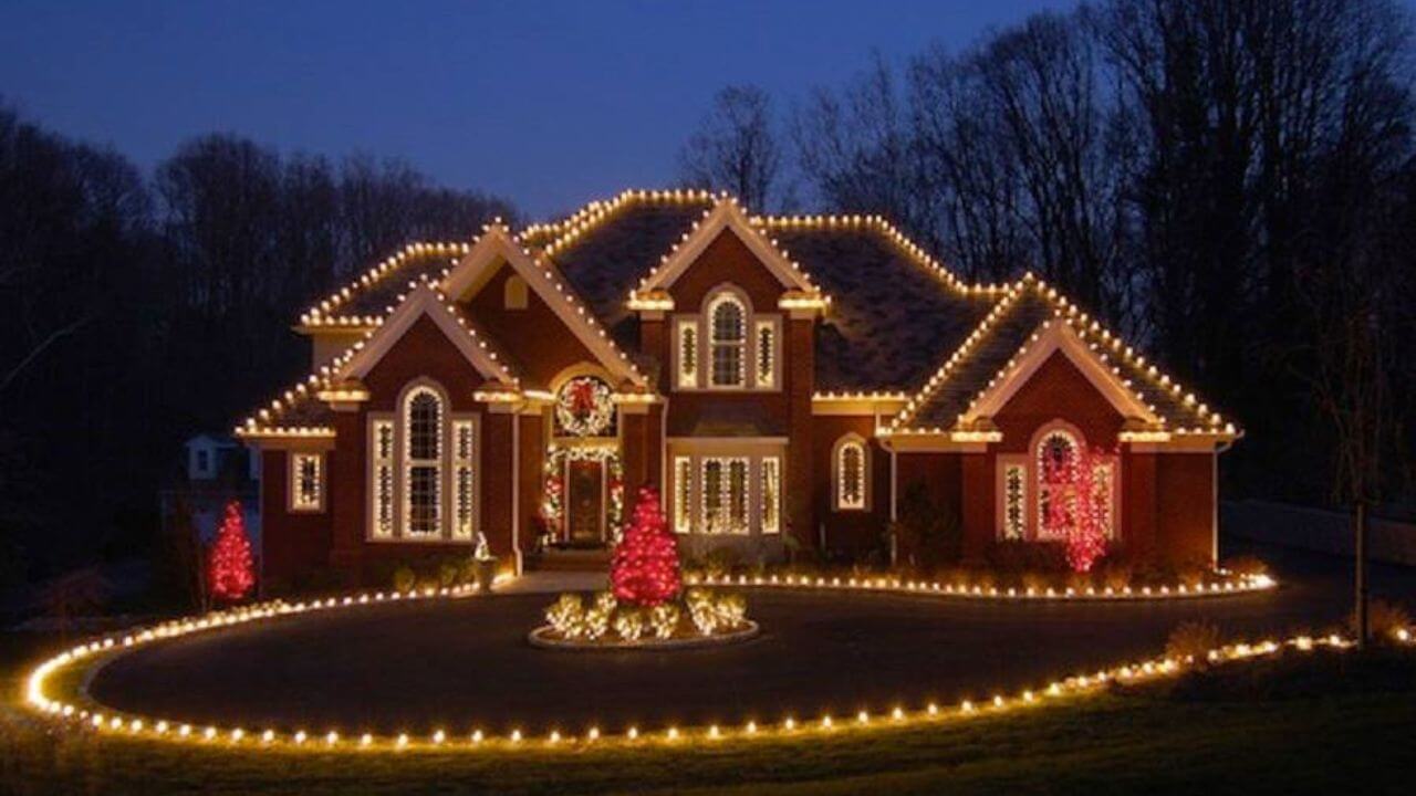 An image of Christmas lights adorning a solar-paneled rooftop