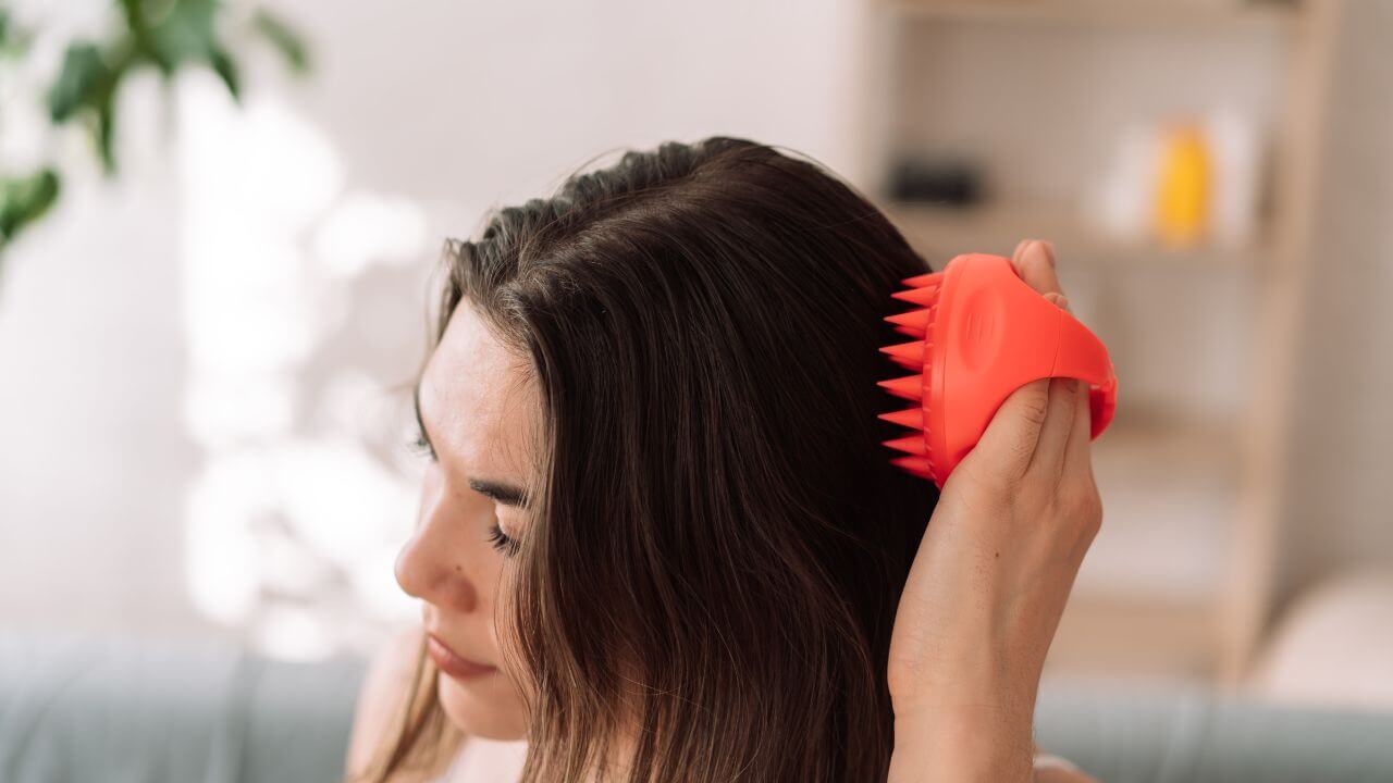 Woman using a scalp scrubber