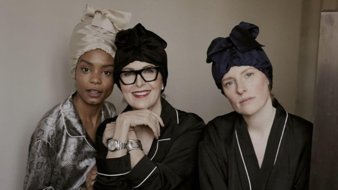 Three women sporting silk bonnets