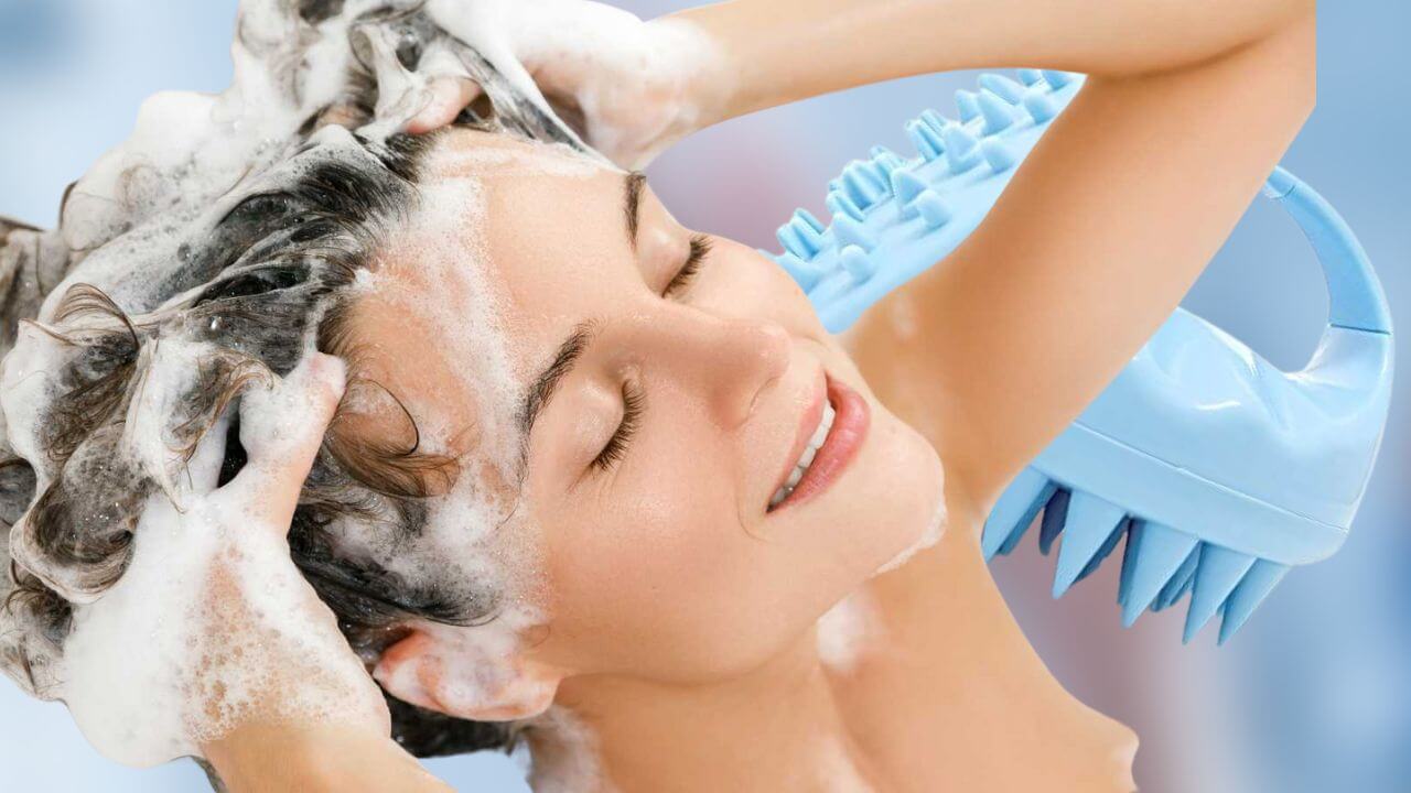 wWoman washing her hair with a scalp scrubber in the background