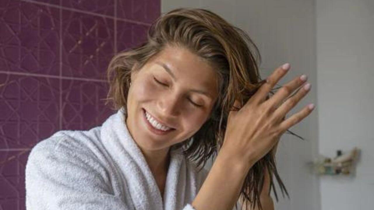 Woman showing pleasure after using her scalp scrubber