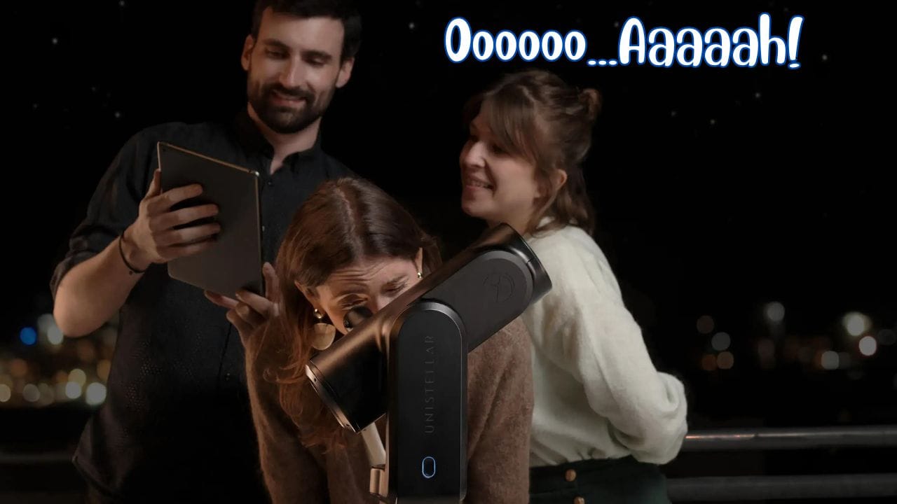 Three people star gazing from a balcony in the city