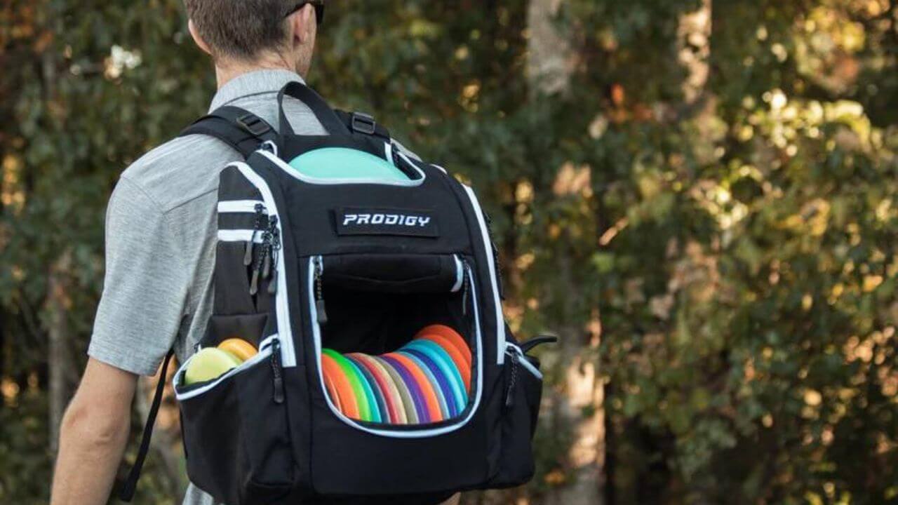 Disc golfer with a back-pack-style disc golf bag