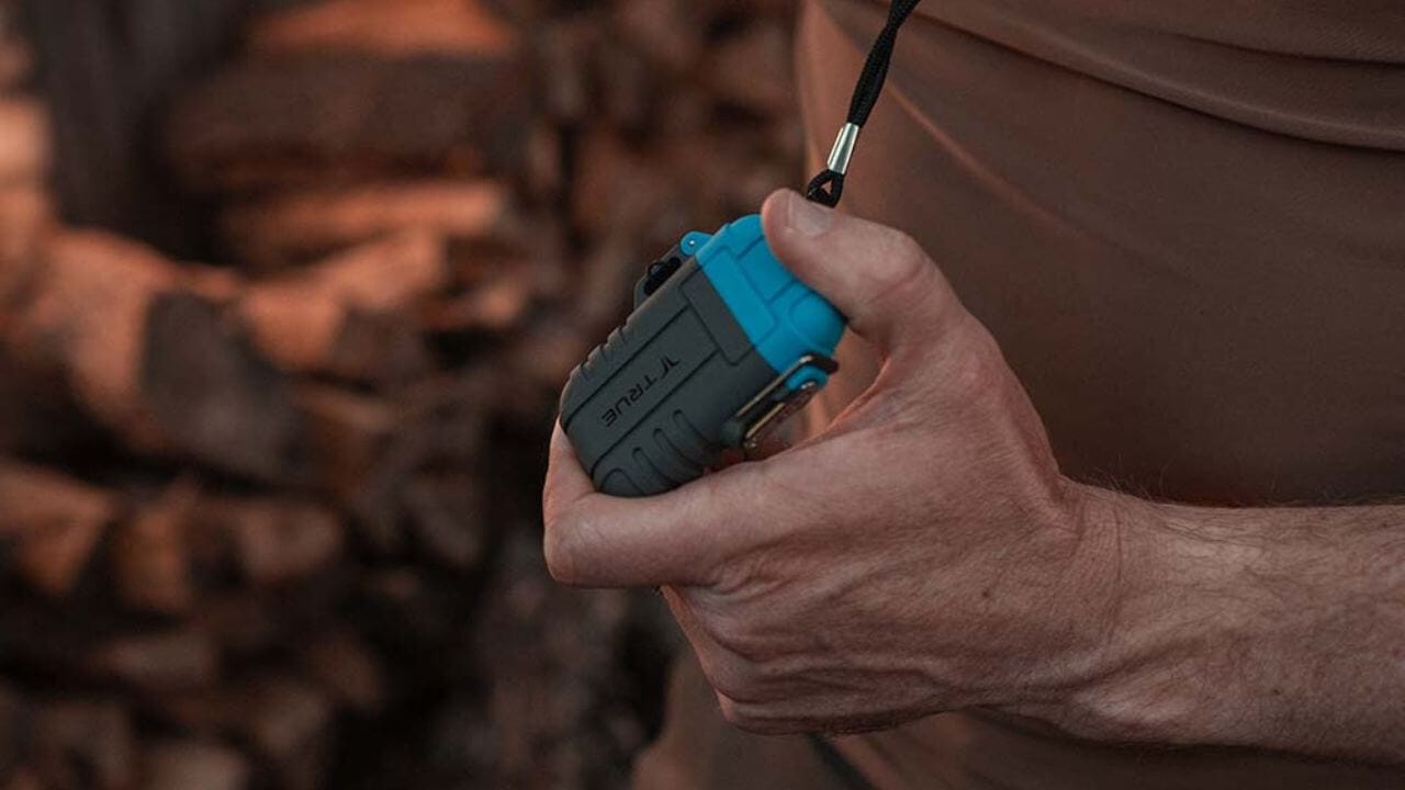 Person on a camping outing holding an electric plasma lighter