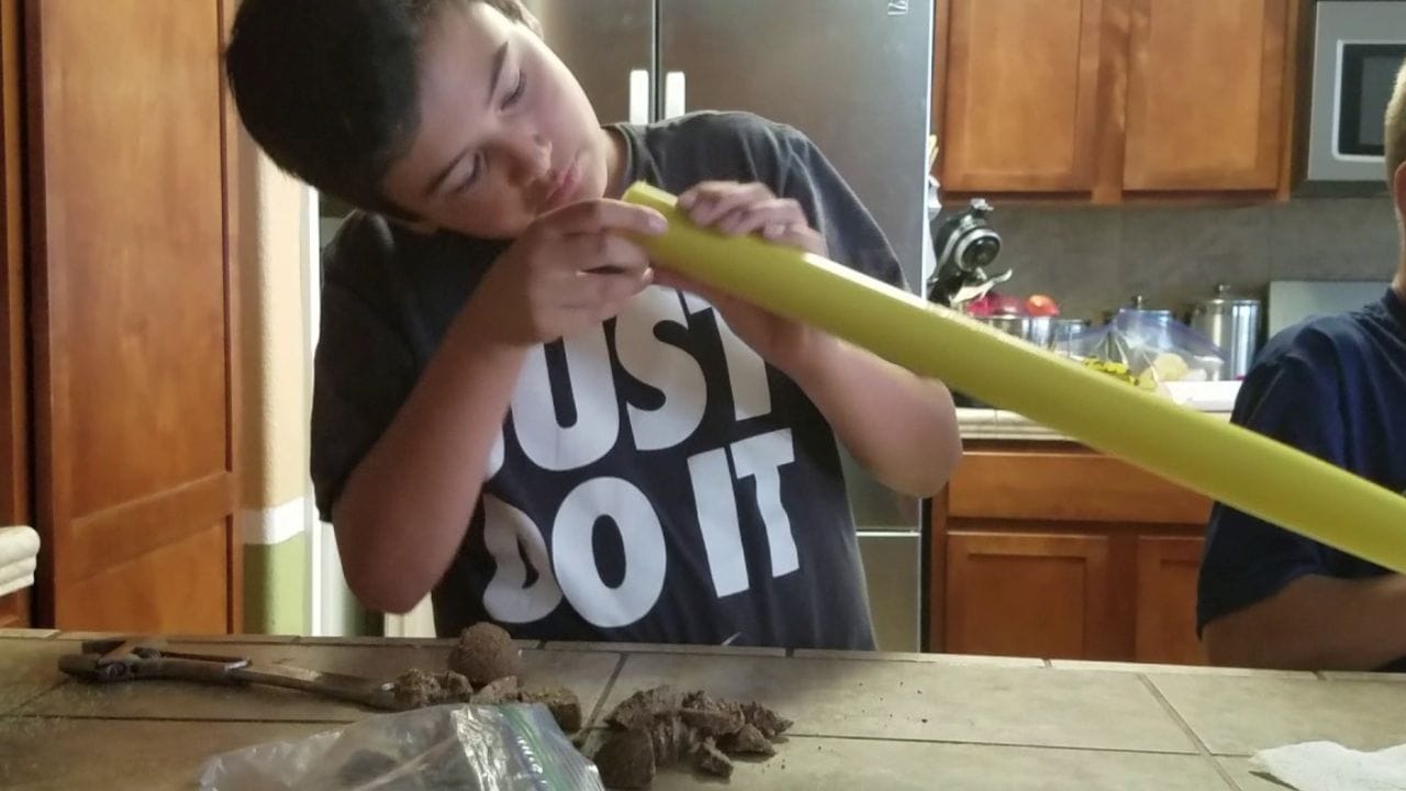 Boy learning to cork a wiffle ball bat