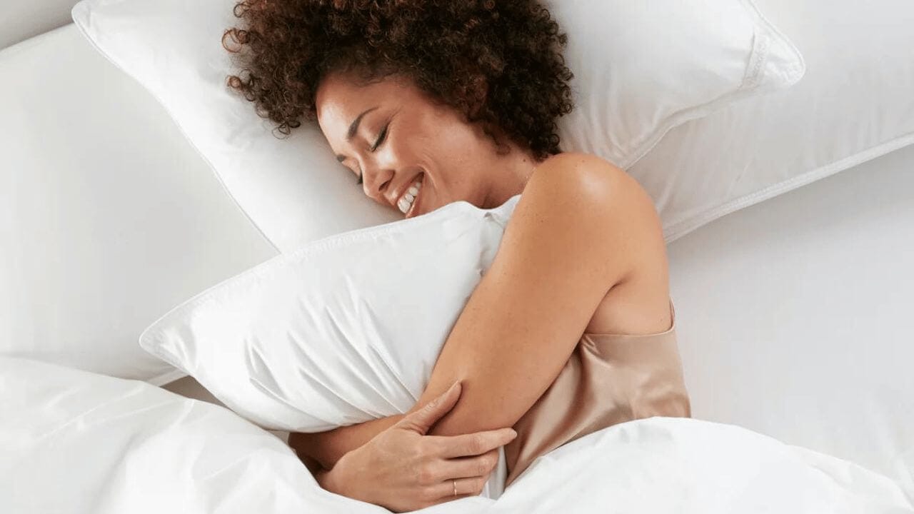 Woman enjoying the feel of a luxury duvet cover