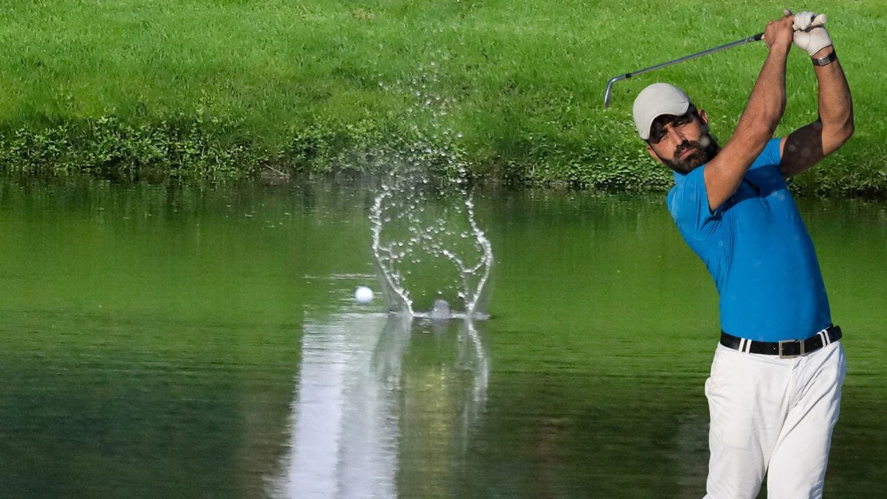 Golfer will need to figure out how to get his ball out of the pond