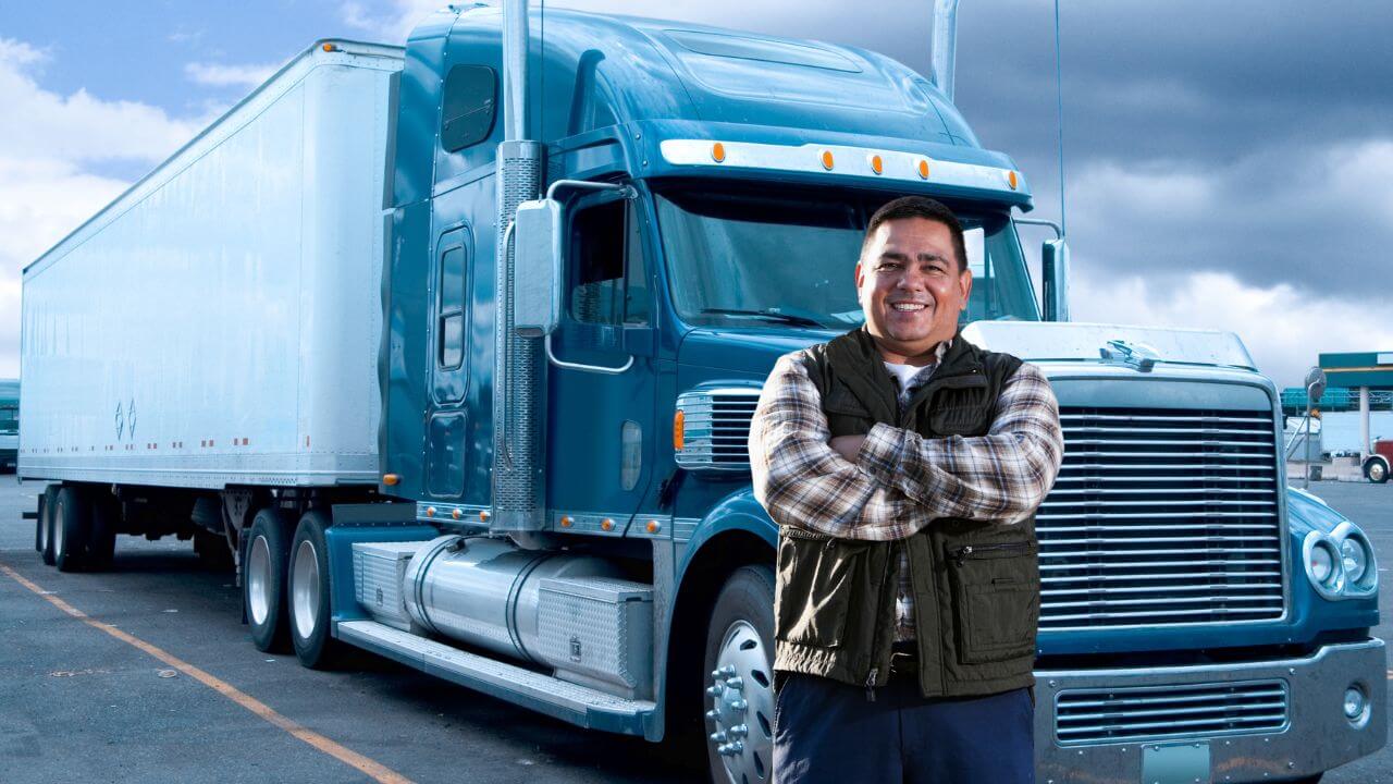 Trucker in front of his truck that is equipped with a dash cam
