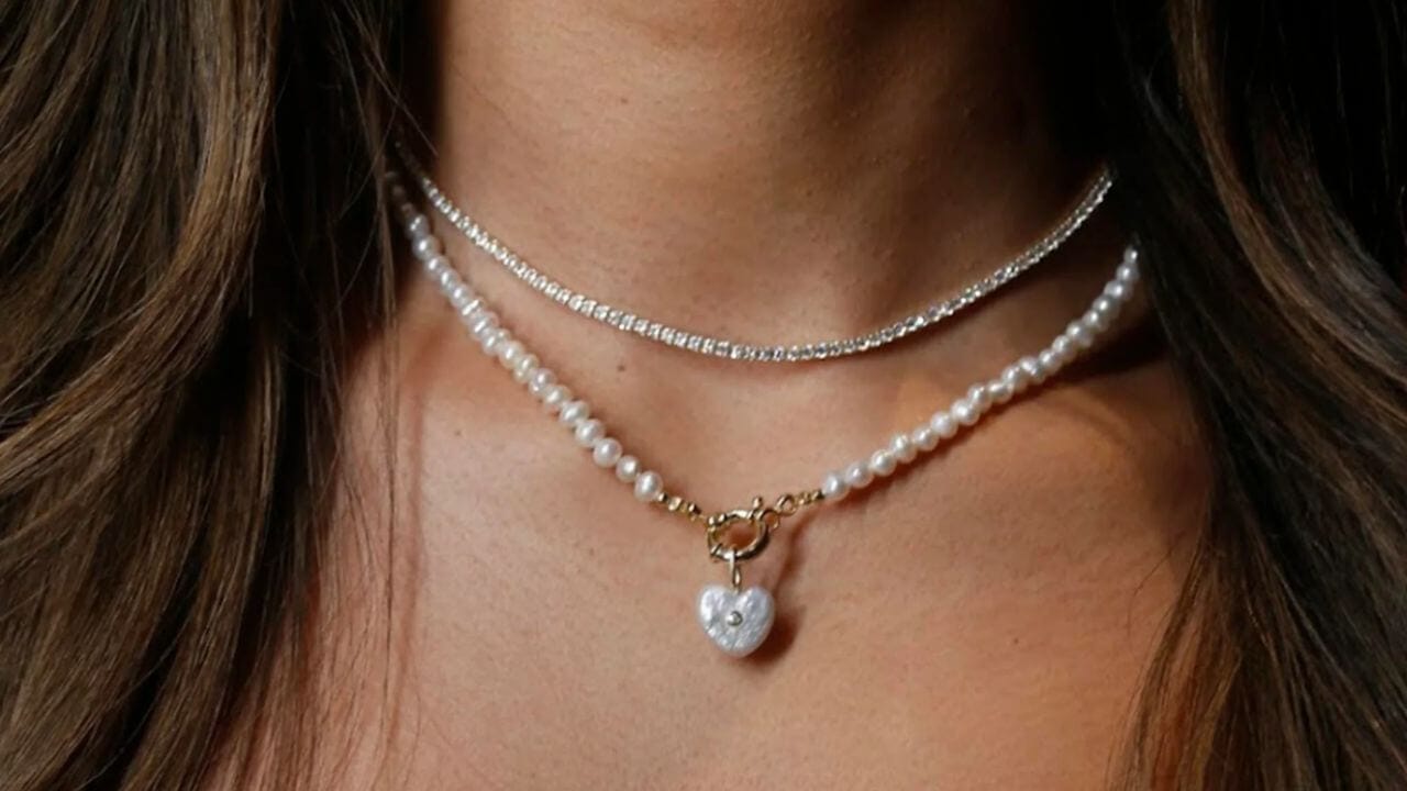 Pendant layered on a tennis necklace