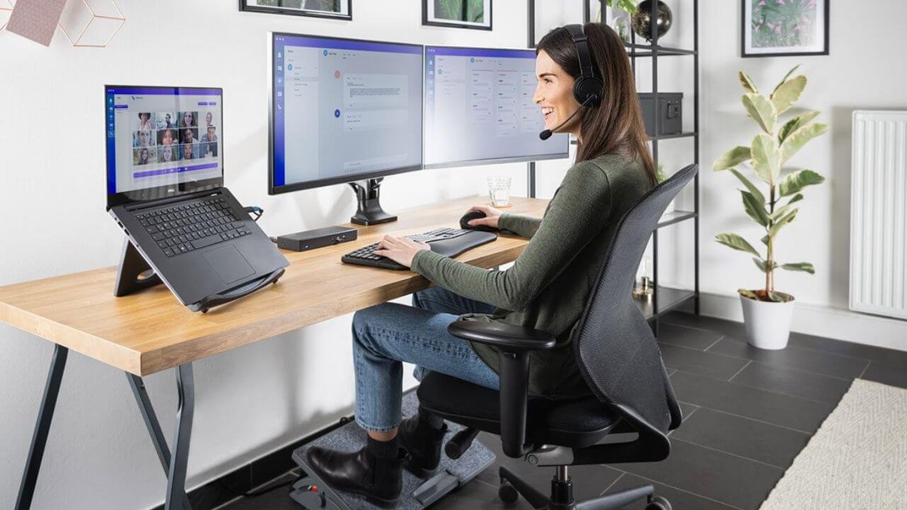 Woman using an ergonomic desk setup for work