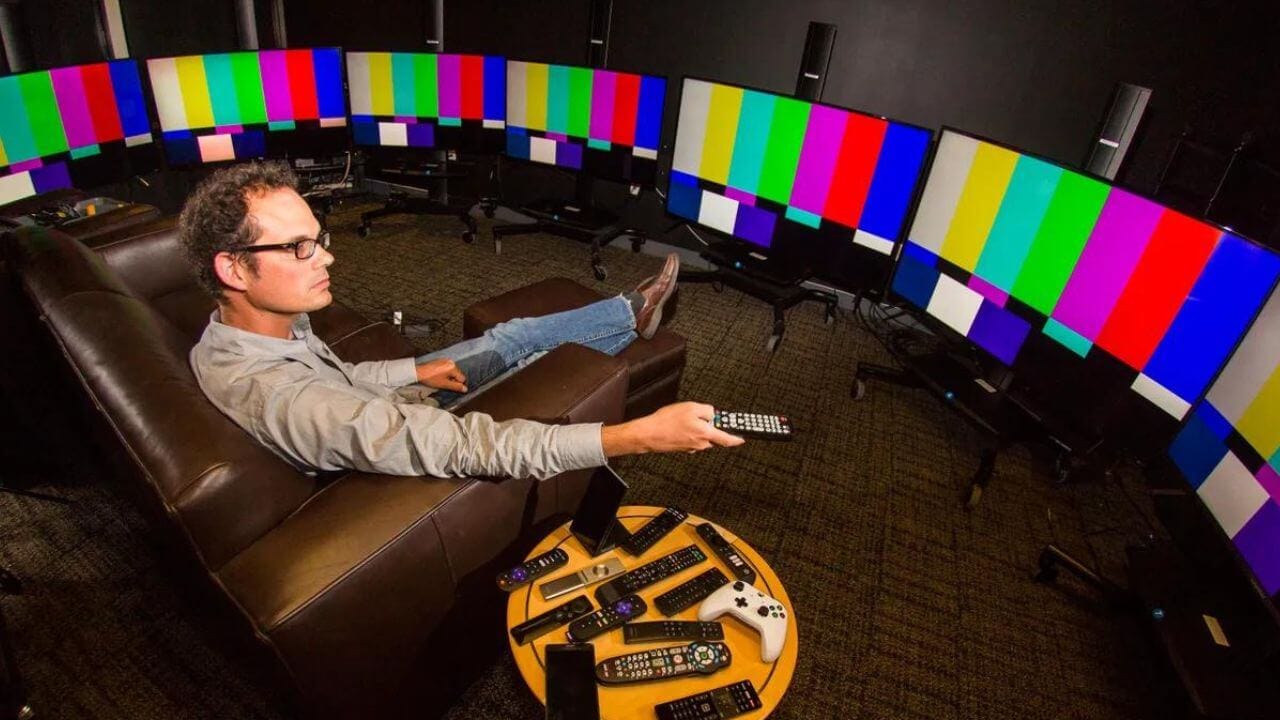 Man viewing visual differences in QLED and OLED monitors