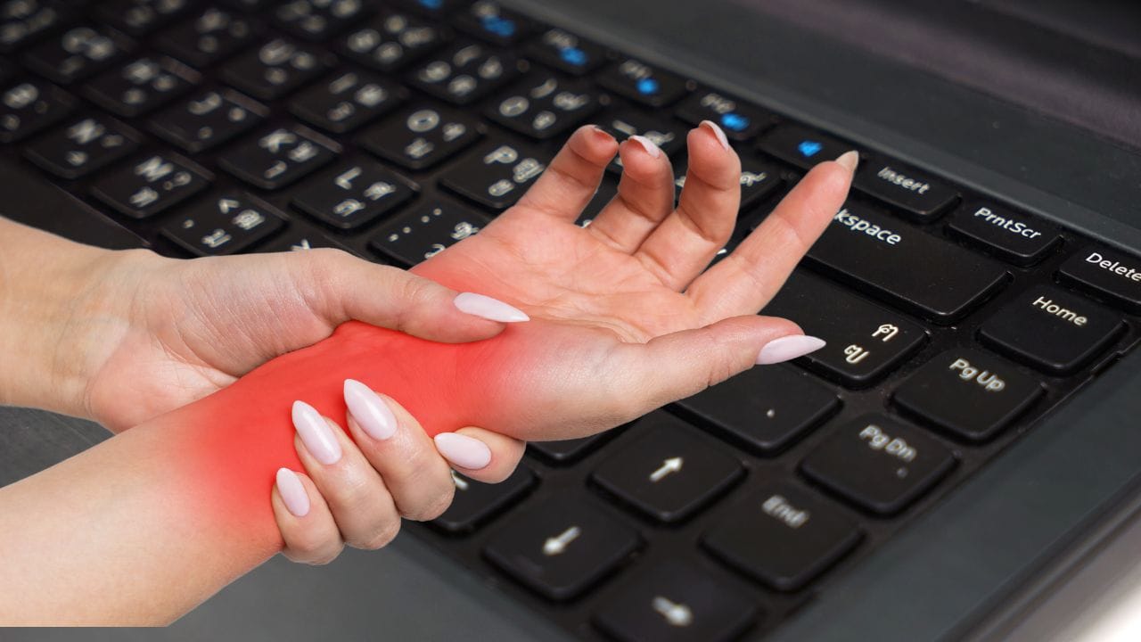 Person with an aching, sore wrist after typing on a computer keyboard