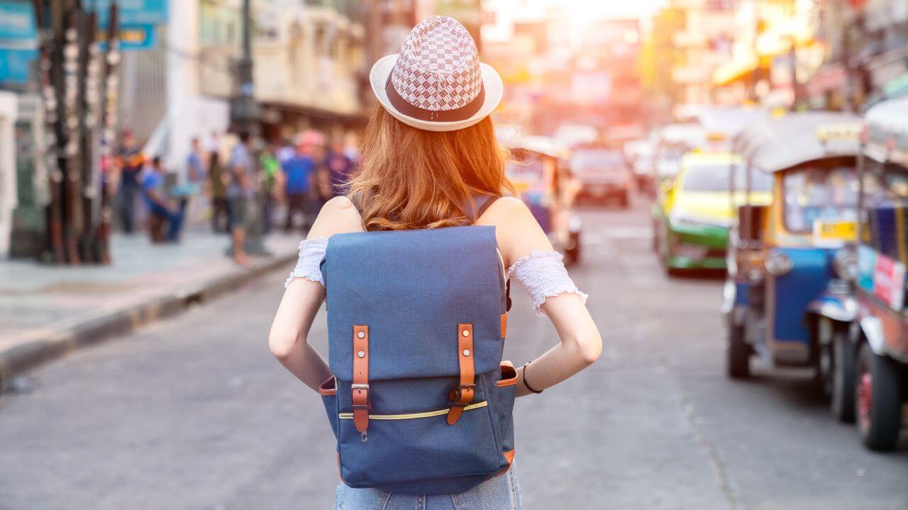 Traveler with a backpack style portable laundry bag