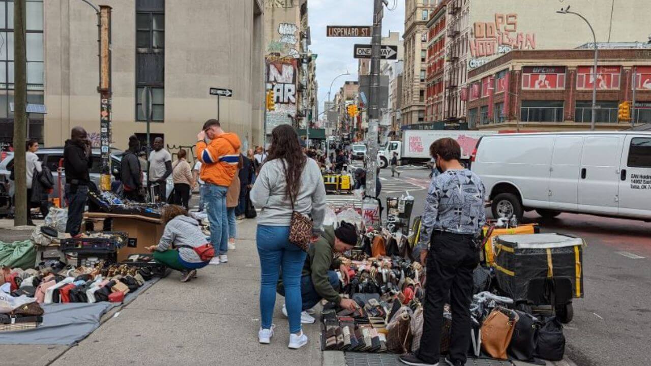 Street market selling counterfeit designer bags as dupe bags