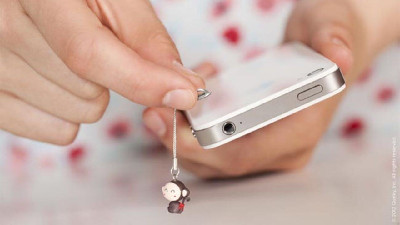 Person attaching a phone charm to a phone