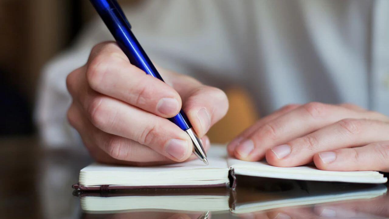 Individual with ADHD making entries in an ADHD bullet journal